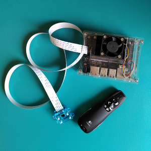 Image of Jetson nano, power supply, camera and presentation clicker.